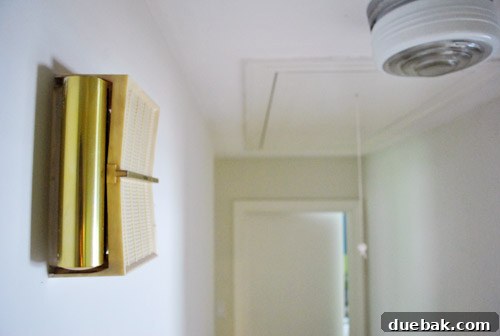 Close-up of an old doorbell unit on the hallway wall