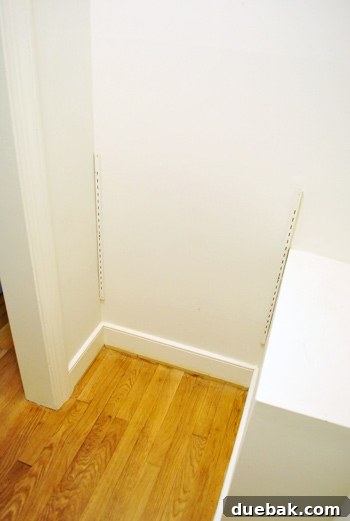 Another view of the emptied closet space, highlighting its readiness for a fresh coat of paint
