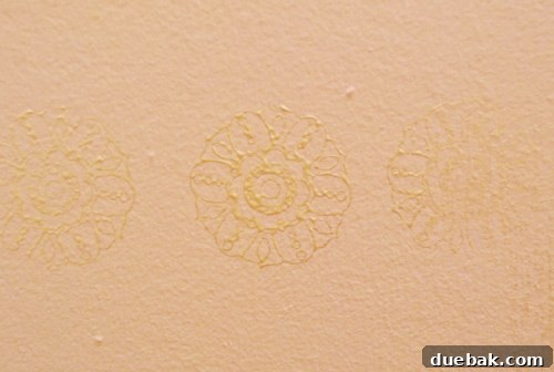 First attempt at hand-stamped metallic medallion pattern on the nursery closet wall