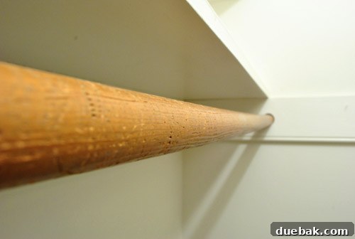 Close-up of a damaged or 'gnawed' hanging bar in Clara's closet, requiring repair or replacement