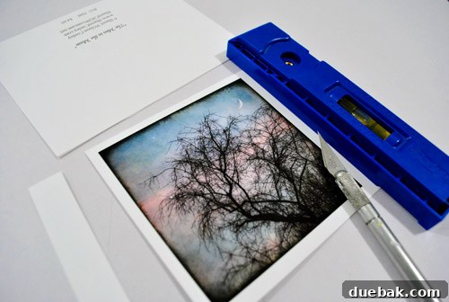 Hands using an exacto knife and ruler to cut a note card