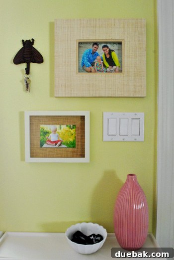 From Drab to Dreamy: Our Laundry Room Makeover 13 Close-up of framed family photos with a charming iron bee accent, adding character