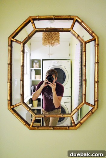 From Drab to Dreamy: Our Laundry Room Makeover 9 Newly hung mirror in the laundry room reflecting the transformed space
