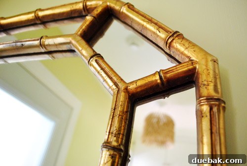 From Drab to Dreamy: Our Laundry Room Makeover 10 Close-up of the mirror's crackled gold finish, showcasing its unique texture