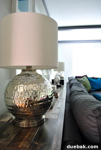 Celebrating April's Apex 7 A beautifully styled console table, adorned with elegant lamps and tasteful decorative accessories.