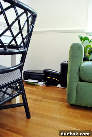 Cluttered corner with printer, paper, and shredder