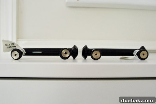 Clever Printer Concealment Ideas 6 Close-up photograph of installed cabinet handles, subtly highlighting a slight crookedness in one handle's alignment.
