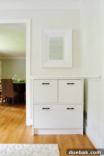 Clever Printer Concealment Ideas 7 Full view of the IKEA Effektiv cabinet with newly installed black glass handles, adding elegance to the room.