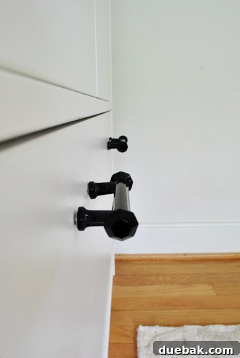 Clever Printer Concealment Ideas 8 Another close-up of a black glass cabinet handle, emphasizing its polished finish and subtle curvature.