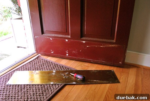 Tools and materials used for front door preparation, including sandpaper, spackle, and cleaning supplies.