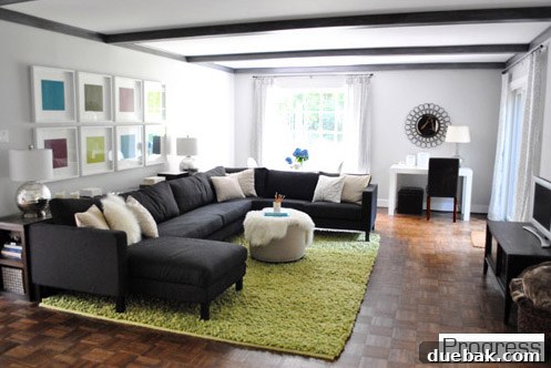 Cozy and functional living room in the current house, featuring a large sofa and plush rug, still a work in progress