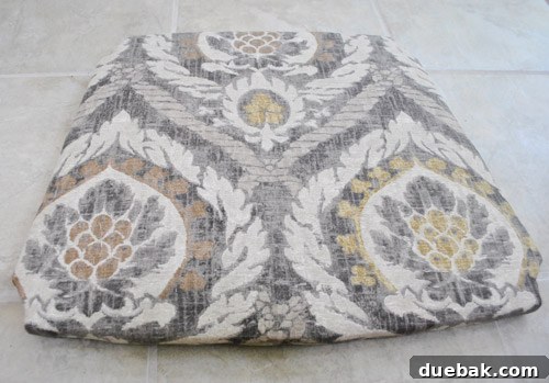 Front view of the newly upholstered rocking chair seat with patterned fabric