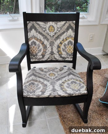 Partially finished rocking chair with newly upholstered seat and painted frame