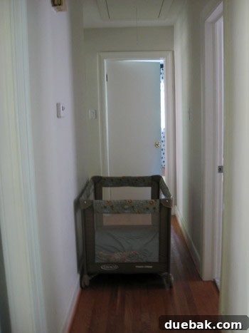 Child sleeping safely in a pack and play in an interior hallway during the storm