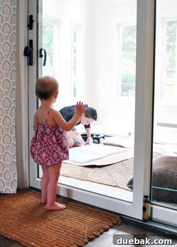 From Thrifted Cabinets to a Massive Shared Desk 15 Sherry painting in the sunroom with her daughter watching