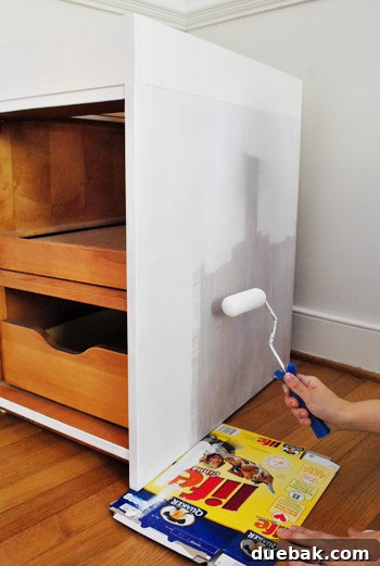 From Thrifted Cabinets to a Massive Shared Desk 16 Painting cabinet bases in place in the office