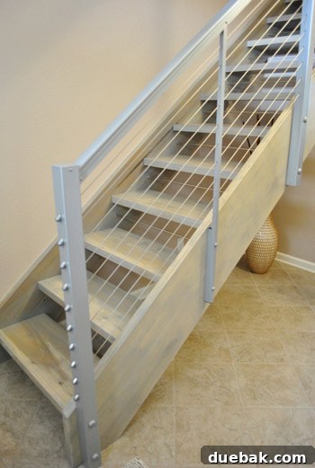 Delaware's Hidden Thrift Treasures 12 Custom-designed open and industrial stairs with light gray-washed wood and thin wire sides, enhancing visual flow