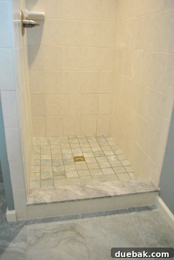 Delaware's Hidden Thrift Treasures 14 Bathroom shower floor tiled with larger tiles cut into smaller squares for a cohesive and custom look