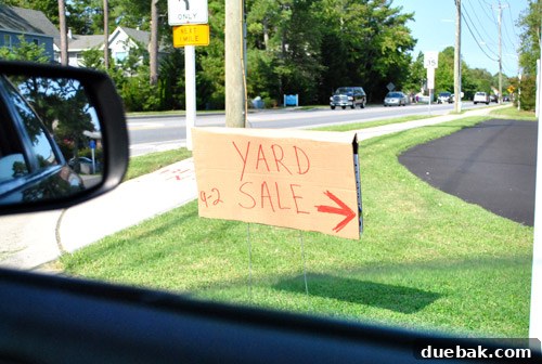 Delaware's Hidden Thrift Treasures 15 Hand-drawn yard sale sign posted on a lamppost, advertising a local sale