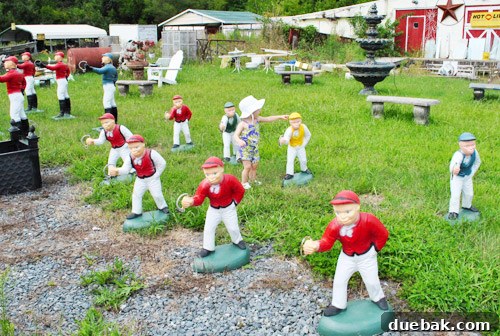 Delaware's Hidden Thrift Treasures 4 Our daughter Clara stands beside lawn jockey statues at the Ole Sale Barn, looking taller than them