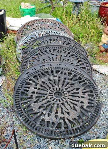 Delaware's Hidden Thrift Treasures 5 Intricate metal grate covers or patio table tops, considered as potential wall art at the barn sale