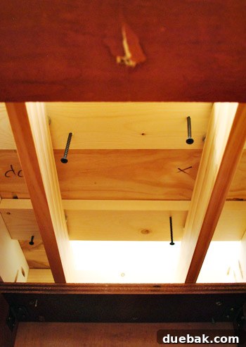 John screwing planks from inside cabinets