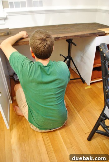 Camera tripod used as a jack to level boards