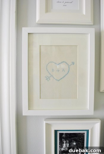 Framed napkin art displayed on a gallery wall