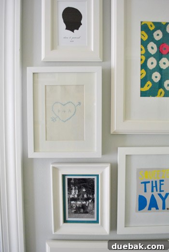 Close-up of the framed cross-stitch art on a wall