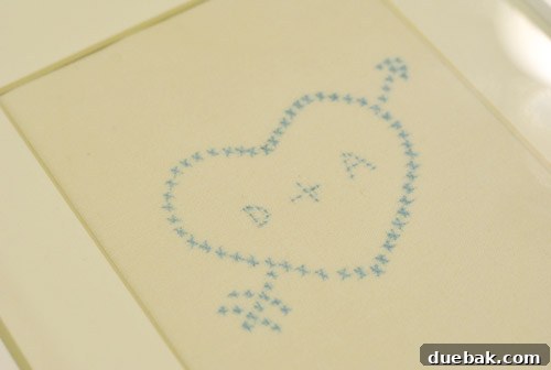 Framed cross-stitch art made from a wedding napkin