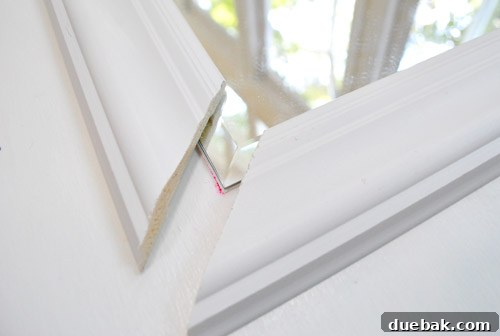 New, thicker trim being applied to the mirror