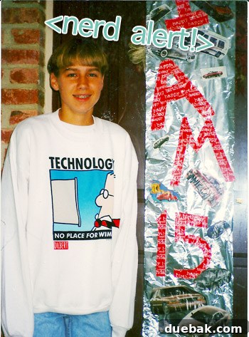 Person wearing a Dilbert sweatshirt with 'Technology: No Place For Wimps' text