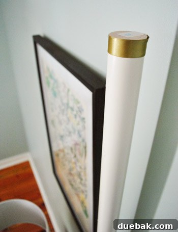 A detailed view of a bedpost top, showing a ribbon securely taped in place, emphasizing the temporary decorative element.
