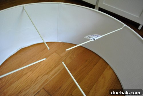 Revitalize Your Old Chandelier With Paint and a Shade Swap 15 Four floating rods inside the drum shade, needing stabilization