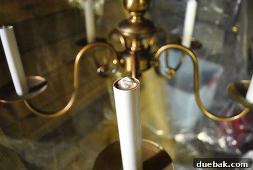 Revitalize Your Old Chandelier With Paint and a Shade Swap 20 Paper towels stuffed into chandelier sockets for protection