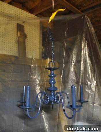 Revitalize Your Old Chandelier With Paint and a Shade Swap 22 Chandelier painted indigo blue, showcasing its updated look