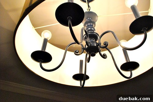 Revitalize Your Old Chandelier With Paint and a Shade Swap 30 Close-up of the new globe-style light bulbs in the chandelier