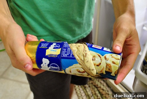 Our Secret to a Fully Stocked Frugal Fridge 4 A close-up of a container of biscuits that has burst open due to spoilage, a strange sight in a darkened kitchen.