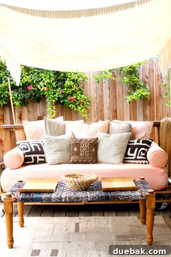 Close-up of the DIY pallet daybed with comfortable cushions on Jaime's outdoor deck.