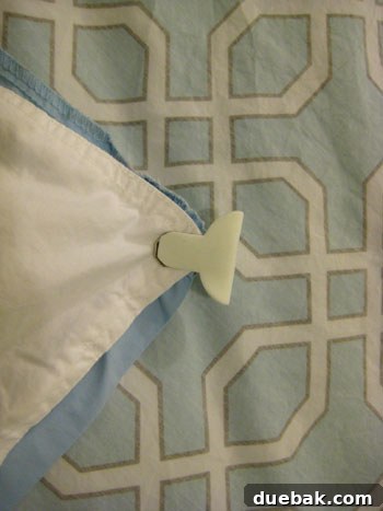 Duvet clips securing the corner of a comforter to the inside corner of a duvet cover.