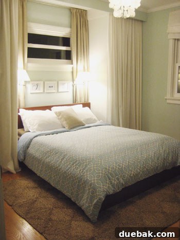A neatly made bed with a blue-gray duvet cover, demonstrating the smooth and well-organized appearance achieved with duvet clips.