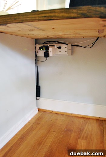 Crown Your Cabinets: An Easy Molding Installation Guide 13 Organized desk with power strip mounted and cables managed