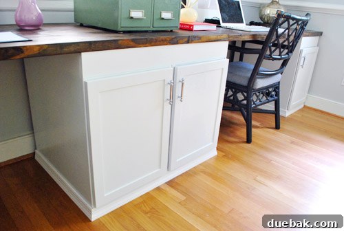 Crown Your Cabinets: An Easy Molding Installation Guide 18 Finished custom built-in office desk with trim and organized cords