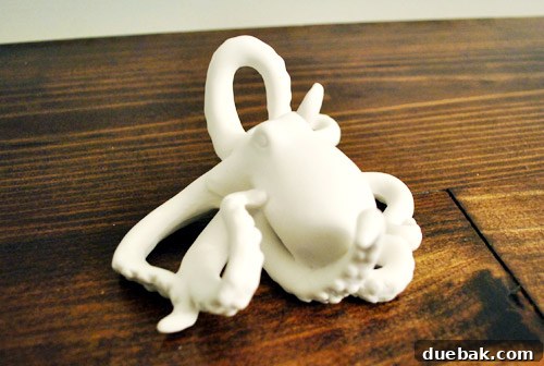 Close-up of a white ceramic octopus figurine with intricate tentacle details.