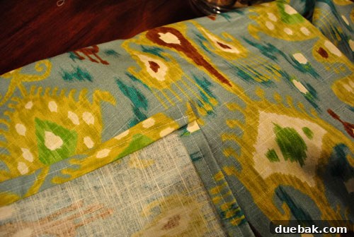 Mastering Chair Painting 12 A roll of patterned fabric, leftover from a dining room curtain project, ready to be used for reupholstering the chairs.