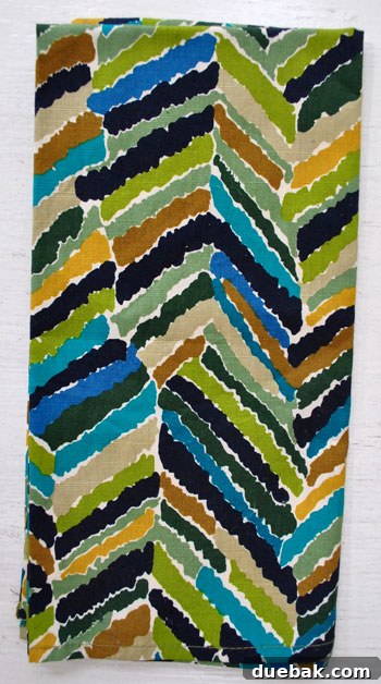 Mastering Chair Painting 4 A close-up of a colorful patterned napkin, named Sue, serving as inspiration for the chair's grellow paint color.