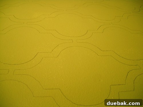 Image showing the stenciling in progress, with green lines being painted on the wall