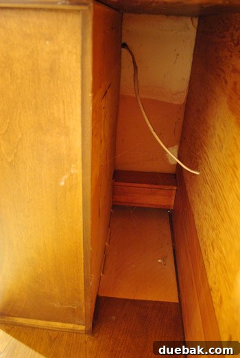 Refrigerator pulled out, revealing the space behind it