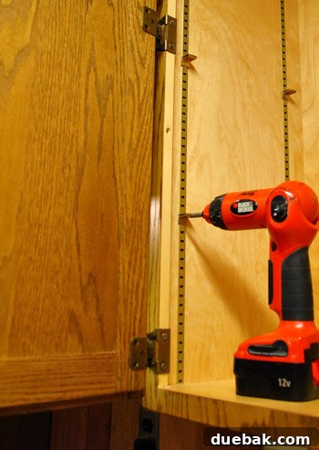 Removing screws attaching kitchen cabinets