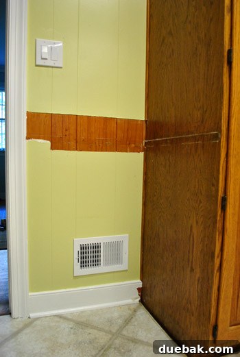 Revolutionize Your Kitchen: Smart Cabinet and Appliance Relocation 9 Exposed unpainted paneling after cabinet removal